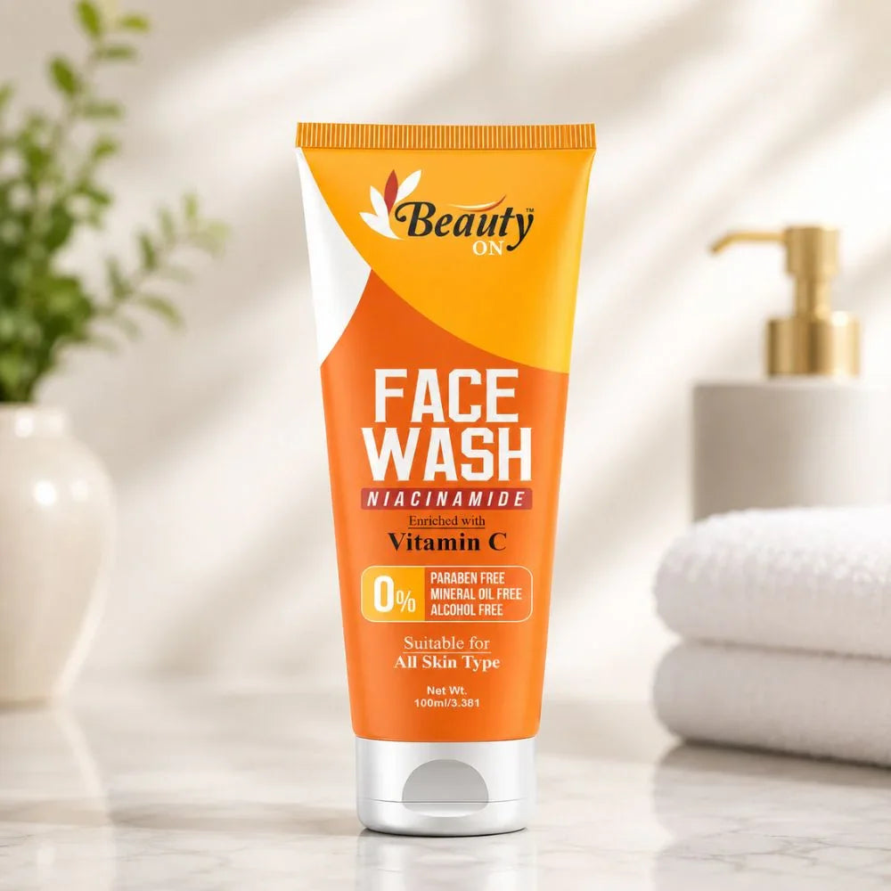 Orange tube of face wash enriched with Vitamin C, paraben-free, suitable for all skin types, on marble countertop